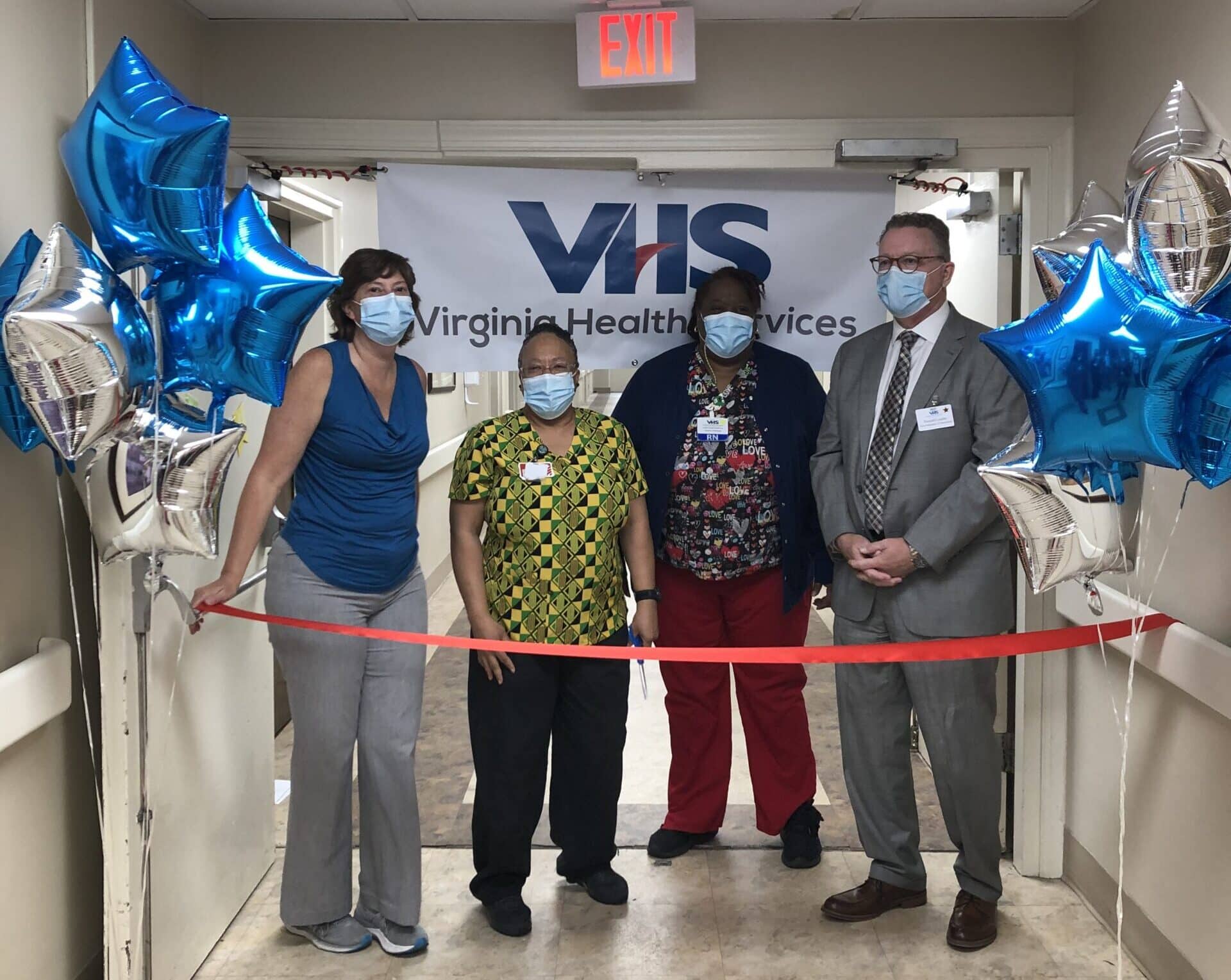 Coliseum Administrator Dudley Haas, the Monroe unit's CNA, Director of Nursing Yolanda Carnegie-Chambers and VHS Vice President of Operations Don Lundin ready to cut the ribbon Tuesday, June 22, 2021, to reopen the Monroe skilled care unit.