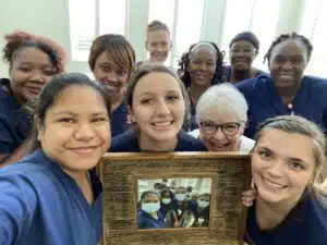 Virginia Health Services apprentices gave instructor Nora Gillespie a framed photo they signed as a graduation gift