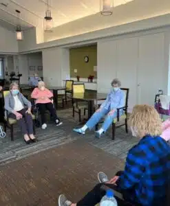 Hamilton residents do leg lifts during chair exercise class