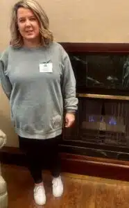 Huntington and Newport Activity Director April VanDyke, pictured by the Huntington's indoor fireplace.