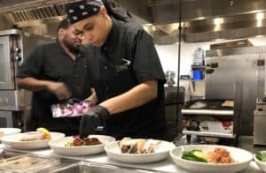Chef Akira Johnston plates the new March specials in The Arbors kitchen