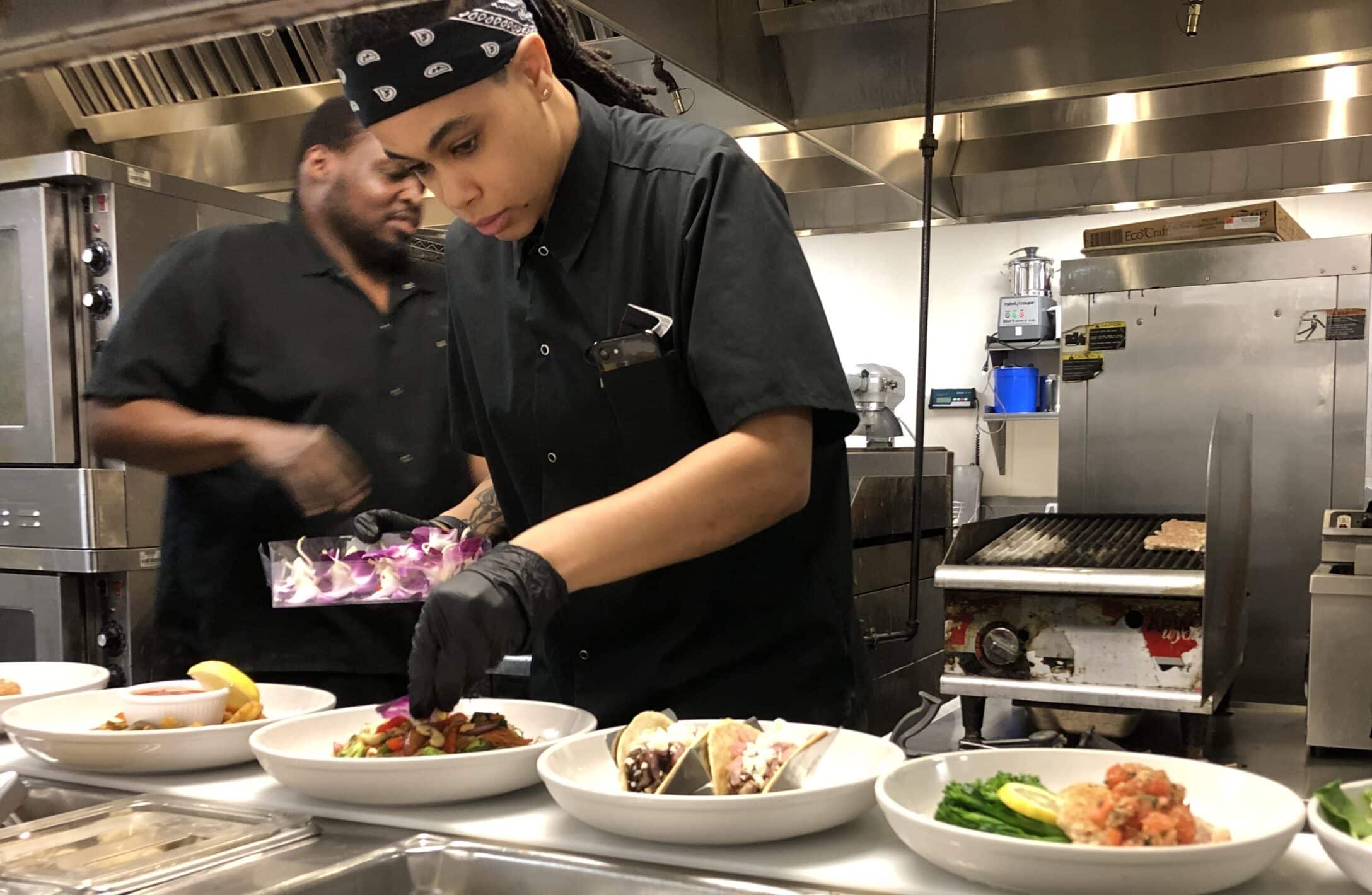 Chef Akira Johnston plates the new March specials in The Arbors kitchen.