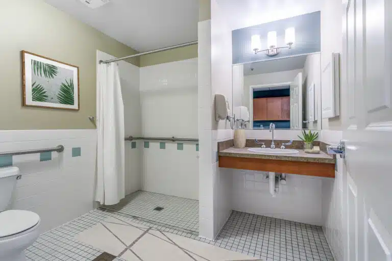 ADA compliant bathroom at The Huntington, with wheelchair accessible shower and sink.