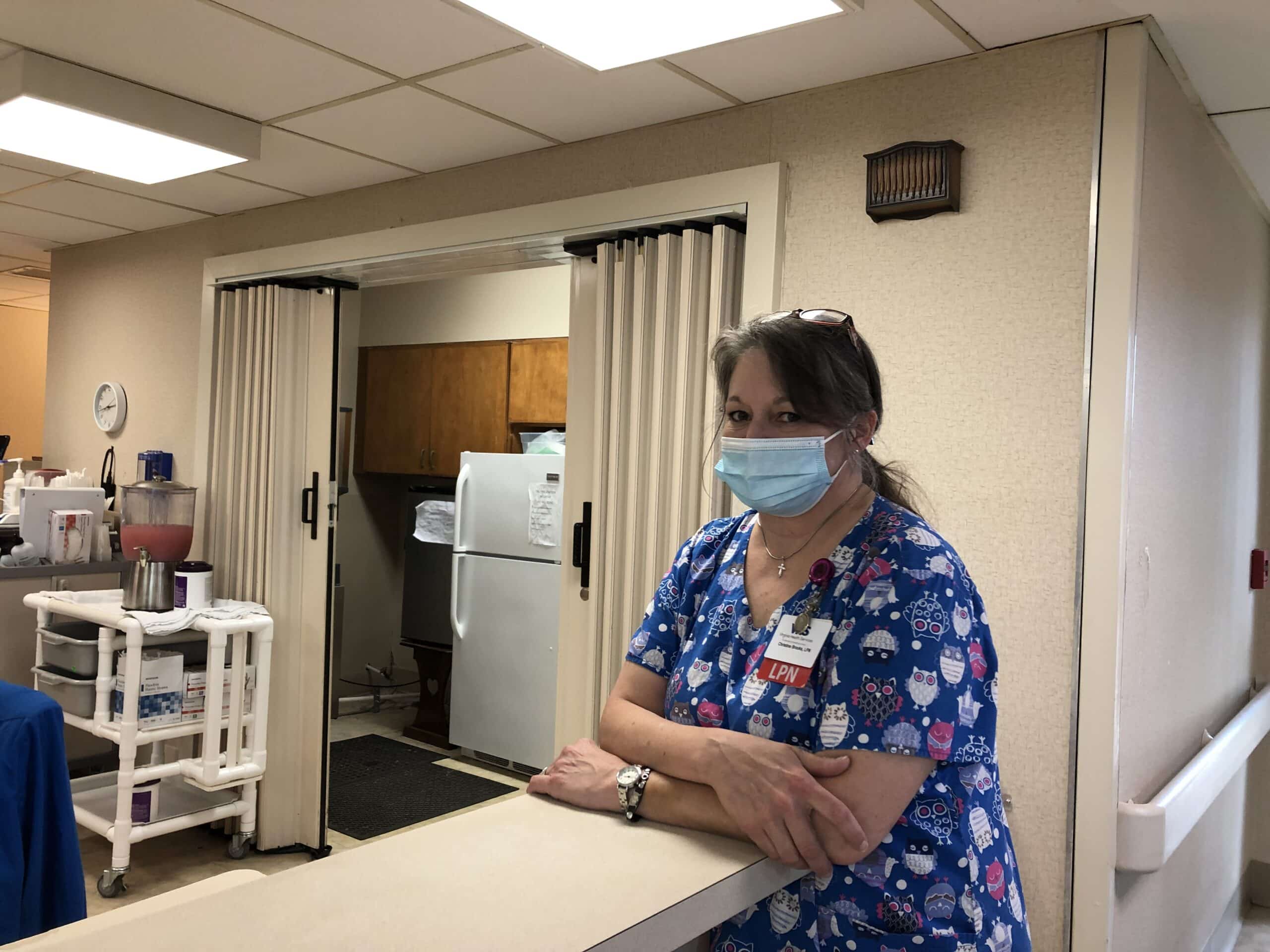 Christine Brooks stands at the nurses station on the Abingdon unit. She found her niche working on the Memory Care unit, truly taking ownership of the wing.