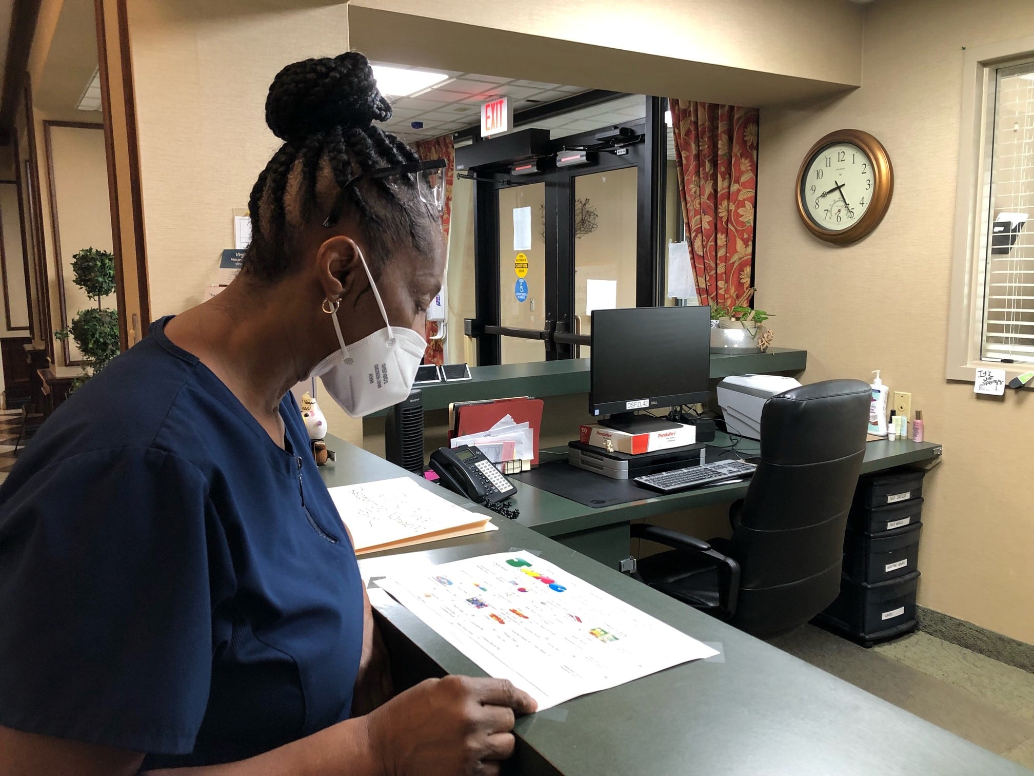 Carrie Isaac, a long-time CNA at The Newport, looks over the calendar at the front desk.