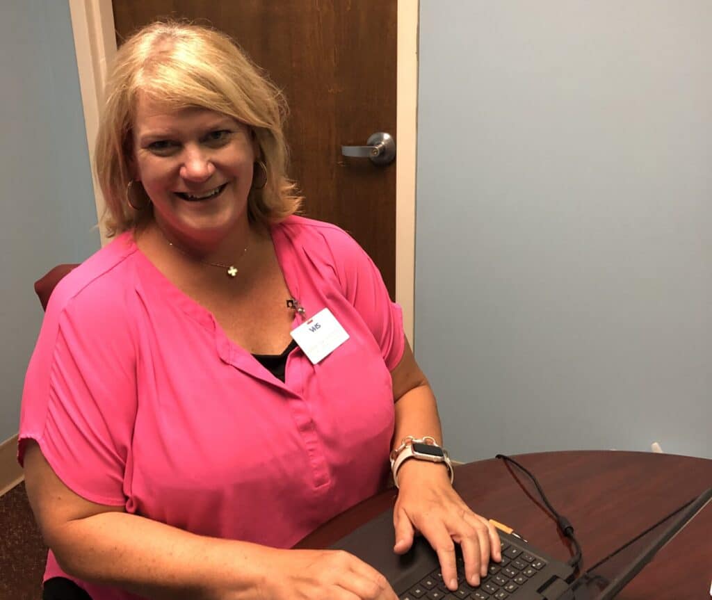 Jennifer Dick seated at a computer