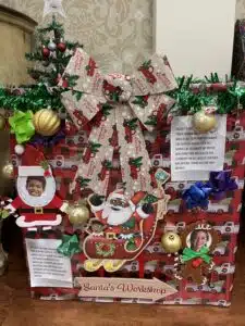donation box decorated for Christmas in the Coliseum lobby