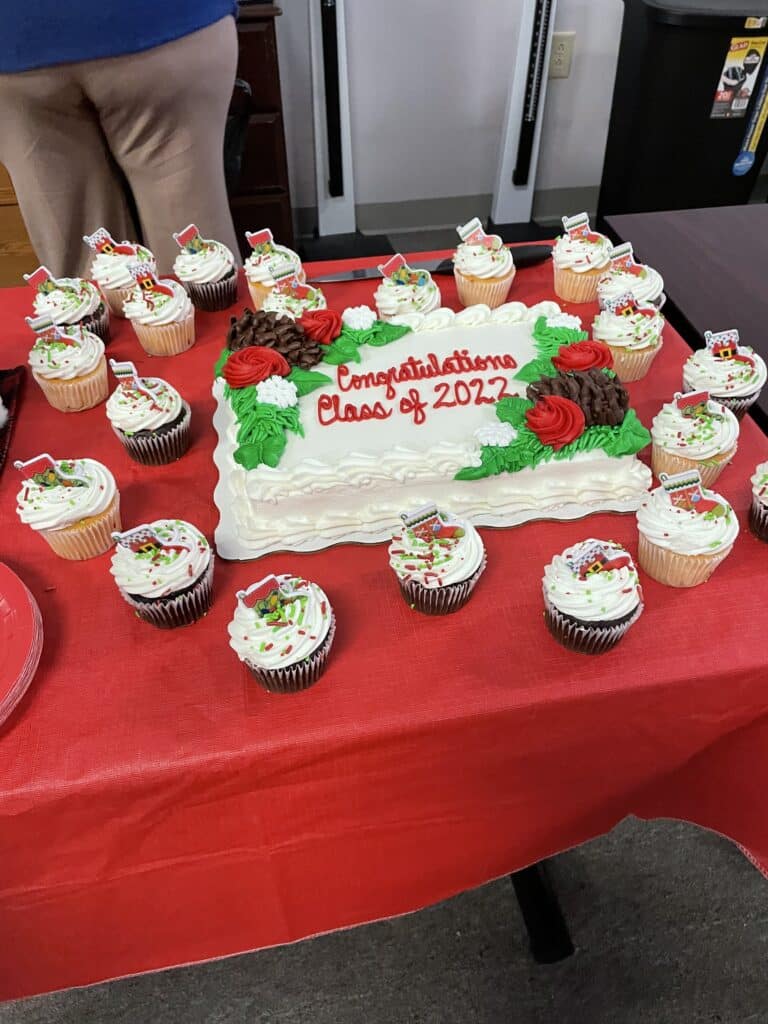 Graduation cake and cupcakes with a Christmas theme.