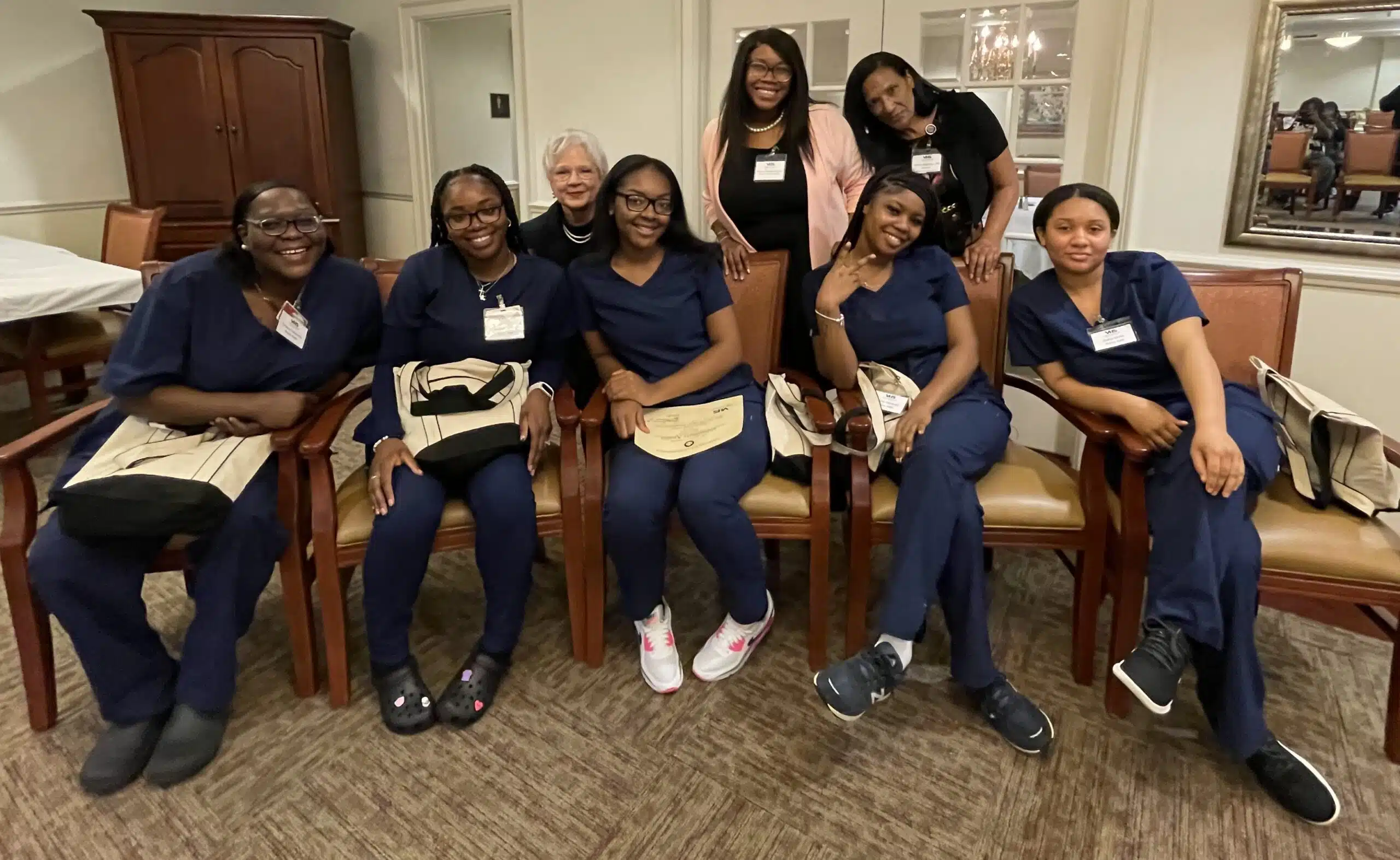 The apprentices pose for a group shot with their instructors during a graduation ceremony March 2, 2023, at The Arbors Independent Living.