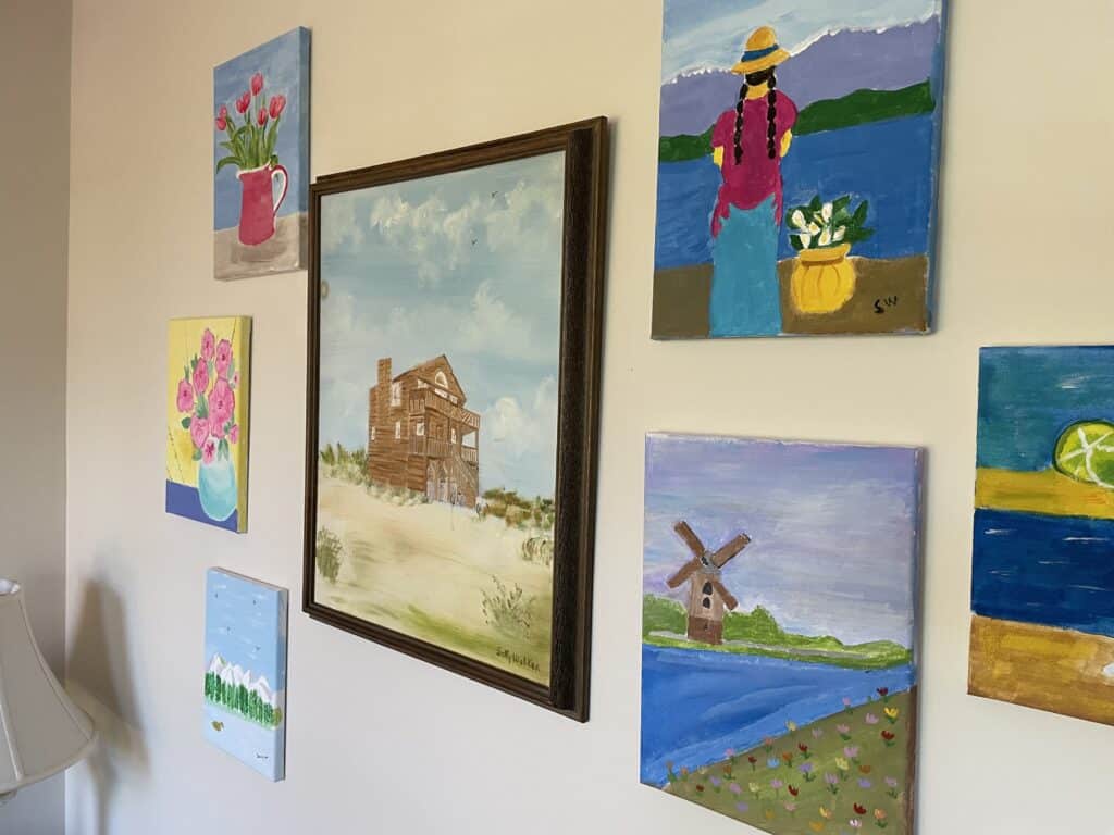 Paintings done by Sally, including one of the family's former Nags Head cottage.