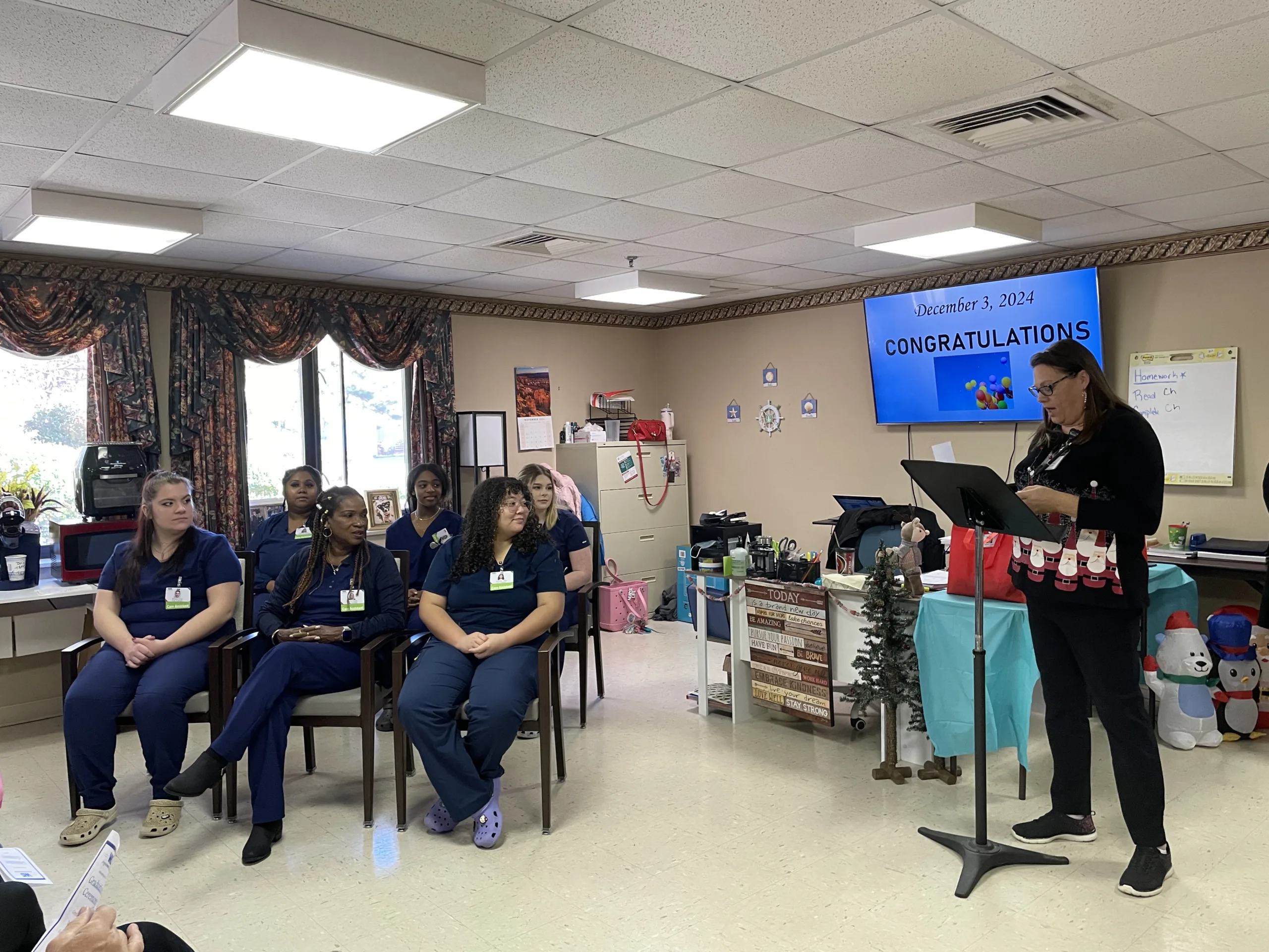 Six apprenticeship graduates listen to instructor Tracy Williams during graduation Dec. 3, 2024.