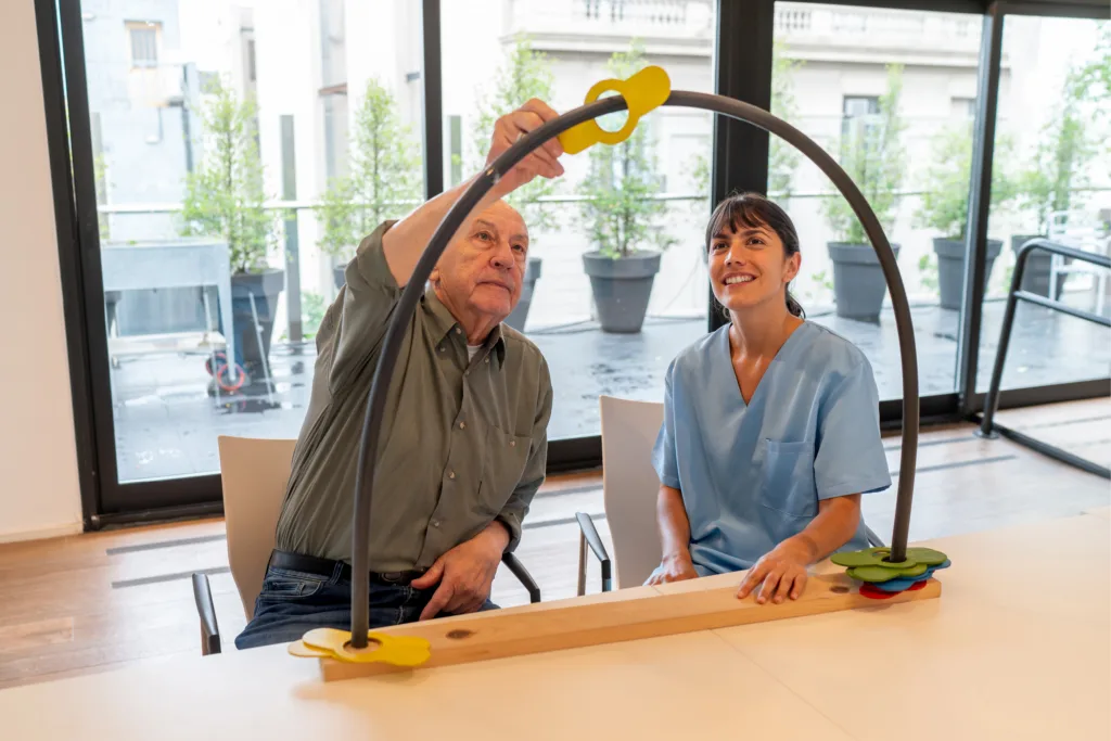 senior man with therapist working on mobility exercise