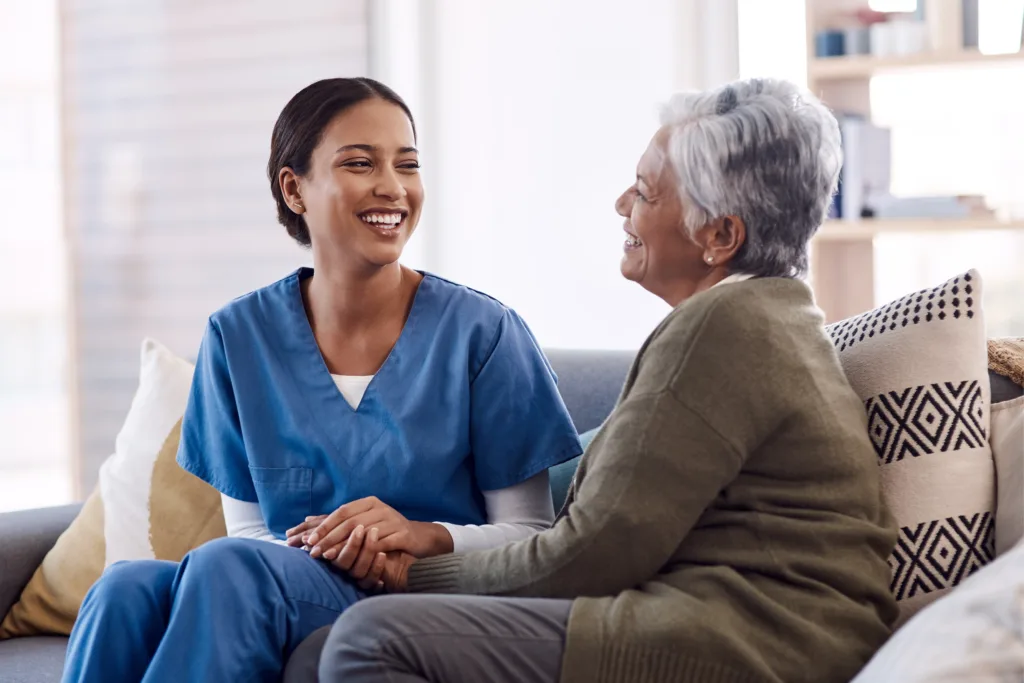 Nurse therapist speaking with a senior on a couch