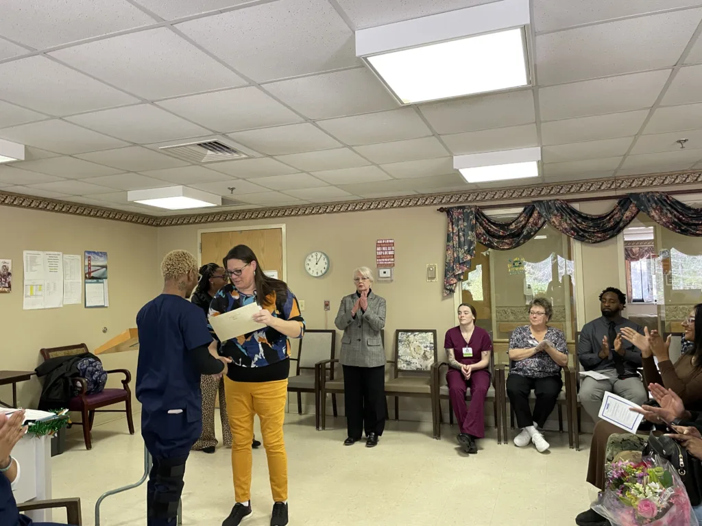 Instructor Tracy Williams hands Clifton Styles, the "life of the party," his graduation certificate during a graduation ceremony Tuesday, February 25, 2025.