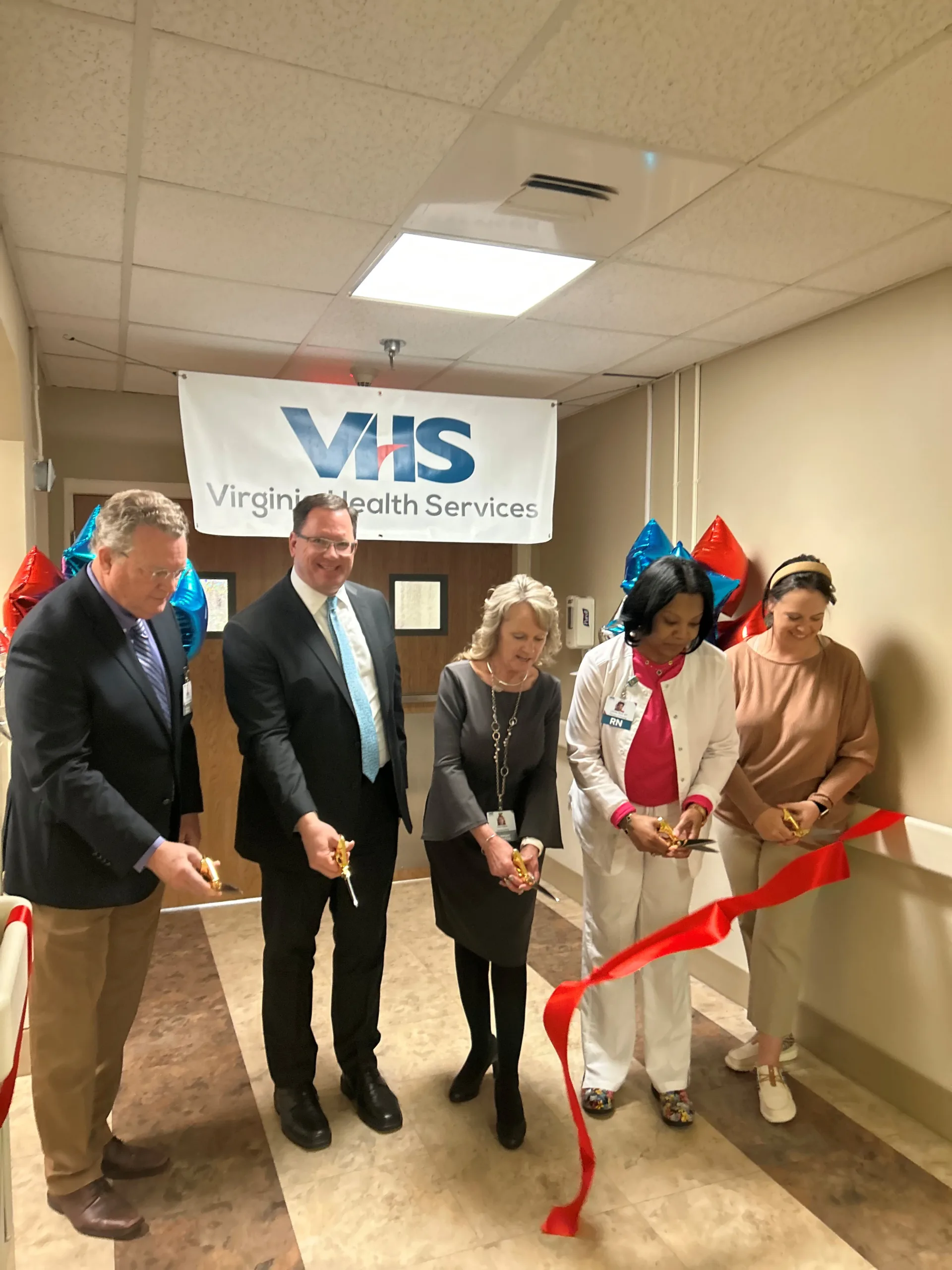 VHS Vice President of Operations Don Lundin, VHS President and CEO Mark Klyczek, Lancashire Administrator Amy Payne, Lancashire Director of Nursing LaTasha Muse and Lancaster by the Bay Chamber of Commerce Executive Director Leslie Jingluski cut the ribbon to commemorate the official opening of the Rappahannock Memory Care Unit on March 5, 2025.